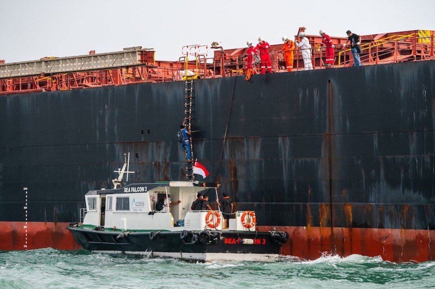 Crew change operation via launch boat alongside a vessel